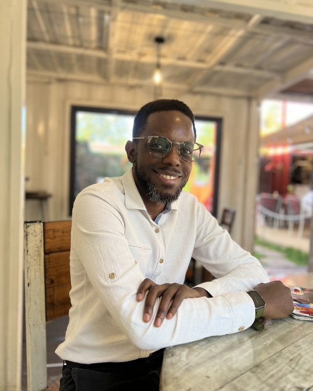 Innocent Maina Mwangi, certified Transcendental Meditation instructor, smiling warmly